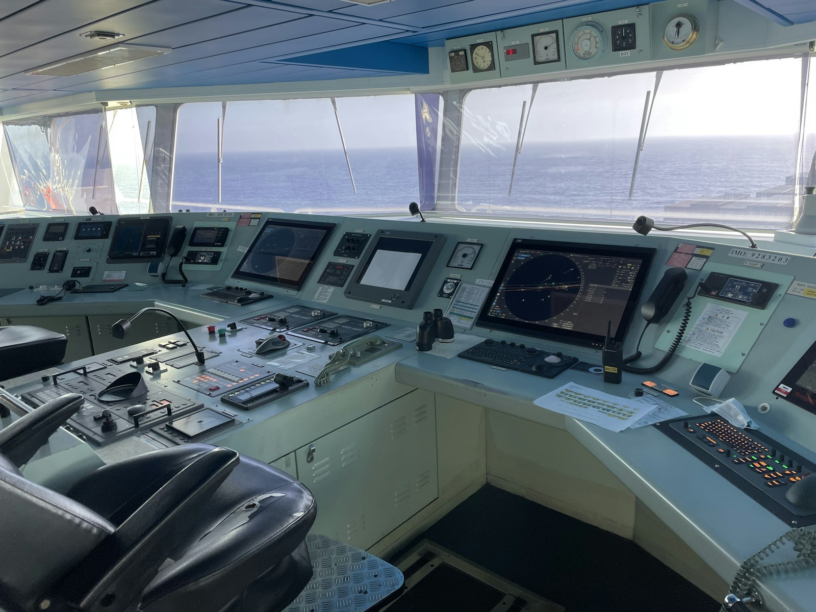 Modern marine navigation and communications equipment on a ship bridge